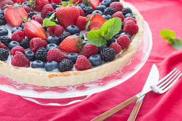 Tart on the plate close up. Homemade dessert with delicious l cream and fresh berries