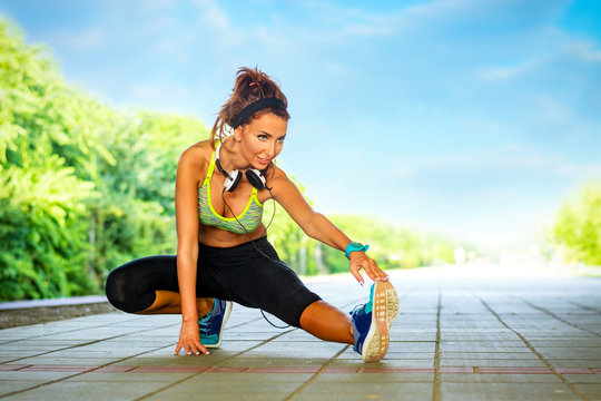 Young Fitness Woman Runner Stretching Legs Before Run