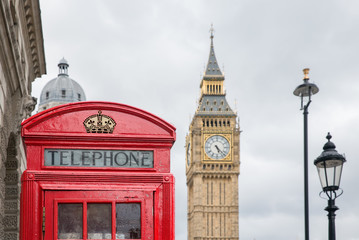 Fototapeta na wymiar Red call box at Parliament square near Big Ben in London