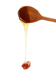Honey and wooden spoon isolated on white background