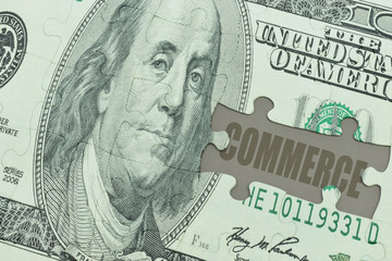 puzzle with the dollar banknote and the text commerce.