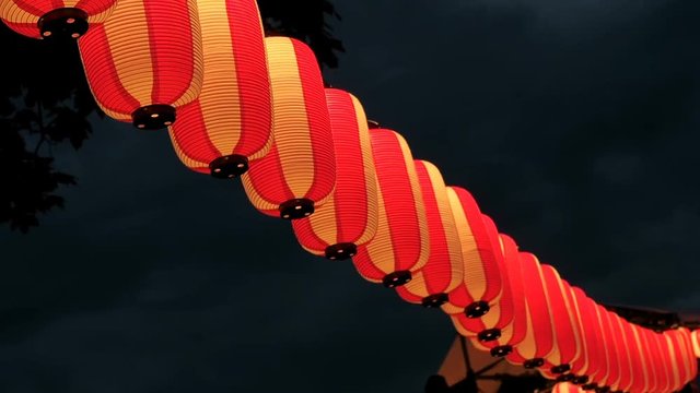 Paper red-white japanese lanterns Chochin shines on dark sky