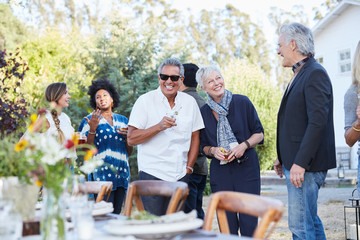 Group of friends enjoying cocktails at an outdoor party