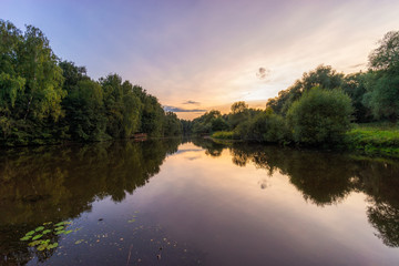 Fototapeta na wymiar Wonderful scenery picturesque sunset on calm river