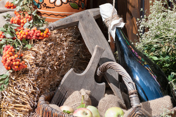 old kitchen utensils and a bottle of wine in a basket background