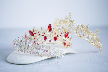 Three different crown for gray hair on white background, close-up © liliyabatyrova