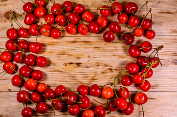 Fresh ripe cherries on wooden table. Top view