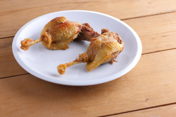 Fried duck leg on a white plate for a restaurant