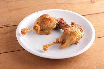 Fried duck leg on a white plate for a restaurant