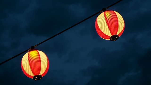 Paper red-white japanese lanterns Chochin shines on dark sky