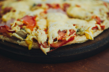 Real pizza with tomatoes, smoked sausage, bacon and parsley.