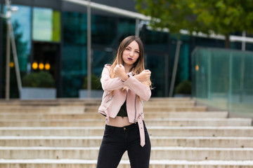 Portrait of beautiful informal fashionable girl on modern building background