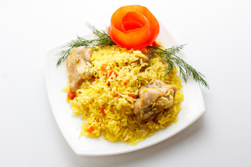 pilaf with meat on a white plate