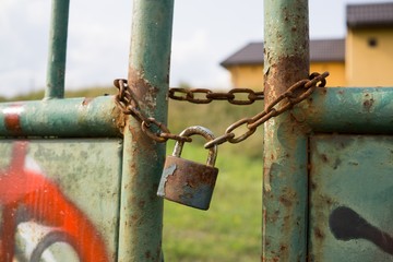 Padlock on the gate in the meadow fence. Slovakia