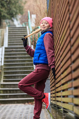 Woman wearing warm sportswear relaxing after exercising