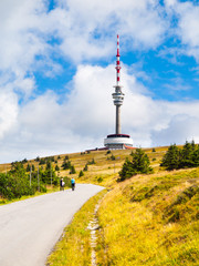 Obraz premium Asphalt road leading to TV transmitter and lookout tower on the summit of Praded Mountain, Hruby Jesenik, Czech Republic.