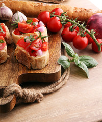Bruschetta with tomatoes, herbs and oil on toasted garlic cheese bread toasted with chopped tomatoe