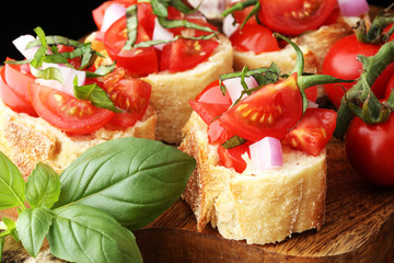 Bruschetta with tomatoes, herbs and oil on toasted garlic cheese bread toasted with chopped tomatoe