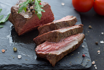 Beef steak on the dark plate. Close up