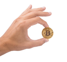 Man's hand holds a gold coin bitcoin coin. The symbol is OK. Isolated on white background