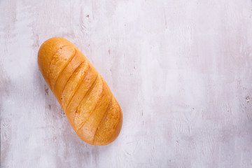 Fresh bread on wooden bakcgraund. Top view with space for your text