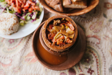 The national Turkish dish in the pot that is broken before use is called Testi-kebab. Restaurant with Turkish food.