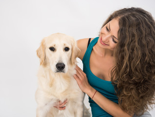 Closeup of woman smilling and looking at camera with her dog isolated on white