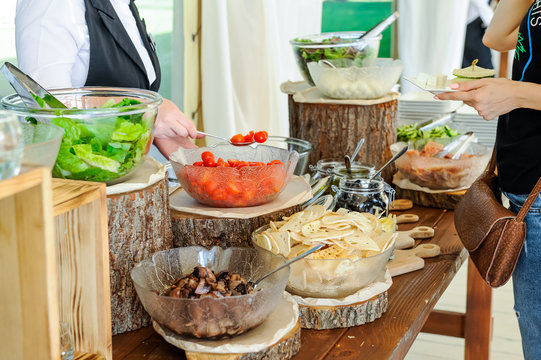Outdoor Cuisine Culinary salad bar Catering. Group of people in all you can eat. Dining Food Celebration Party Concept. Service at business meeting, weddings. Selective focus.