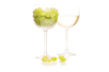 White wine in a glass of grapes