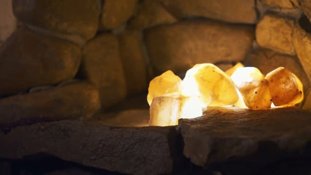 Smoldering embers lights in stone wall shelf. Shot with Sony a7s and Atomos Ninja Flame