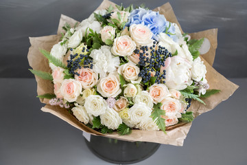 Rich bunch of peonies, roses and hydrangea flowers, green leaf. Fresh spring bouquet. Summer Background. Selective focus.