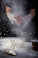 Baker clapping hands of flour