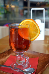 Pouring healthy tea. Hot tea on a glass cup on a wooden table. 