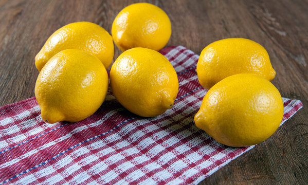 Still life of fresh lemons on a napkin