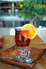 Pouring healthy tea. Hot tea on a glass cup on a wooden table. 