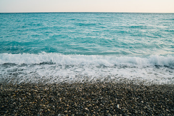Turquoise ocean with grey rocks France