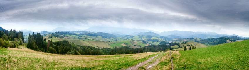 Fototapeta na wymiar Summertime rural landscape banner, panorama - view at dirt road against the background of mountains Western Carpathians, Zilina Region in the Slovakia