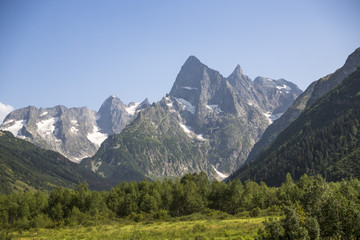 Fototapeta na wymiar Горный пейзаж, Красивый вид на горные вершины в живописном ущелье, солнечная погода, дикая природа Северного Кавказа