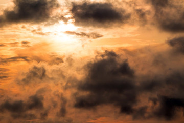 Orange sunset behind the clouds