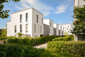 Fototapeta na wymiar Modern townhouses in a residential area, new apartment buildings with green outdoor facilities in the city 