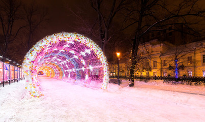 Entrance to the glowing decorative tunnel decorated with Christmas