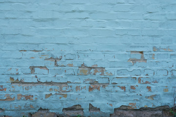 brick wall with peeled blue paint abstract background