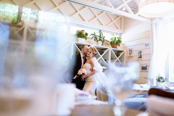 Wedding couple indoors is hugging each other