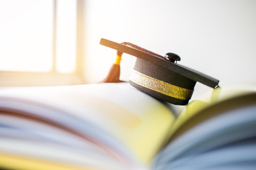 Graduation cap on Books step in Library room of campus and university, Concept of abroad...