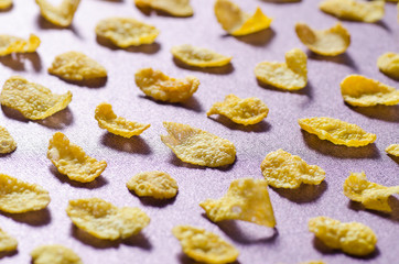 Row Corn flakes arranged on purple background,Breakfast or meal