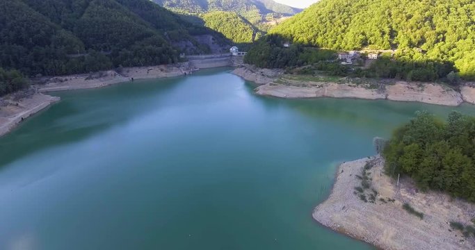 Aerial, beautiful lake with a dam barrier among the hills