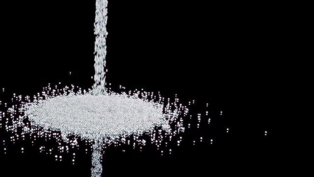 Sea salt crystals dropping onto a reflective surface.