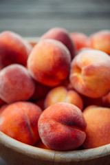 Fototapeta na wymiar A group of ripe peaches in a bowl