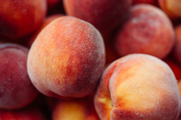 Close up of a group of ripe peaches in a bowl