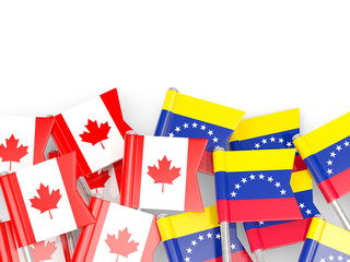 Flag pins of Canada and Venezuela isolated on white
